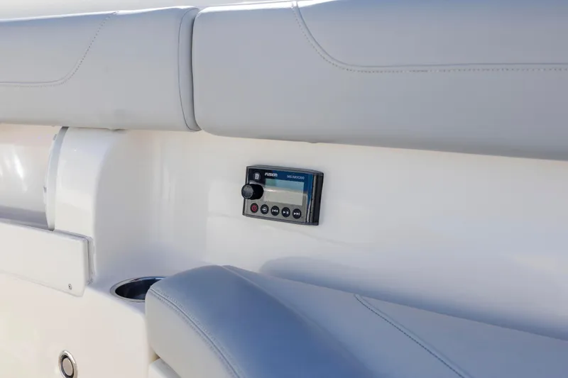 Slide: The Image of 2019 Scout 355 LXF boat interior with Fusion stereo system and cushioned seating. - 34