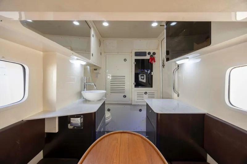 Slide: The Image of Interior of 2019 Scout 355 LXF boat, featuring modern design with sink and seating area. - 42