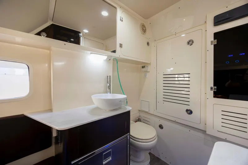 Slide: The Image of 2019 Scout 355 LXF boat interior with modern bathroom amenities. - 44