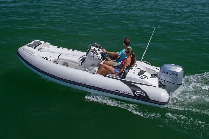 Slide: The Image of Manufacturer Provided Image: 2025 Walker Bay Generation 450 DLX boat cruising on open water. - 1