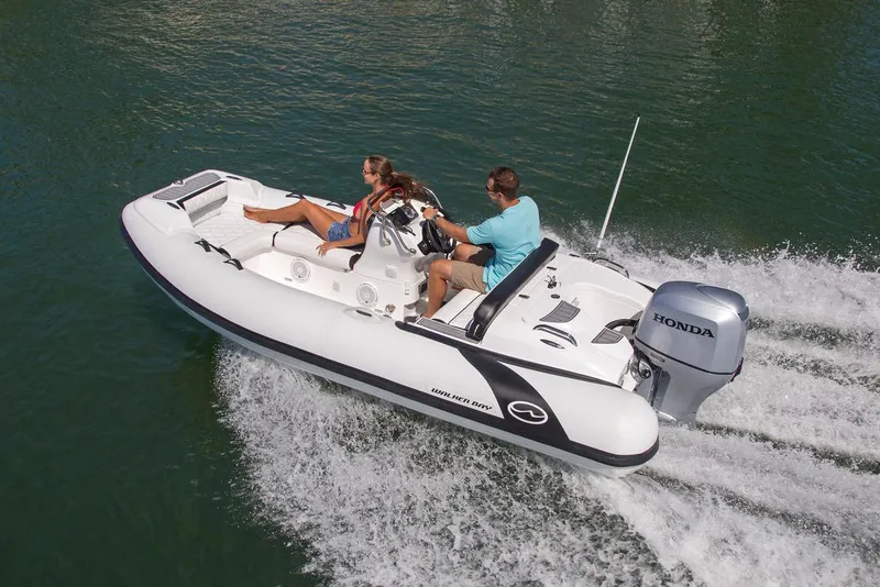 Slide: The Image of Manufacturer Provided Image: 2025 Walker Bay Generation 450 DLX boat cruising on water with two passengers. - 3