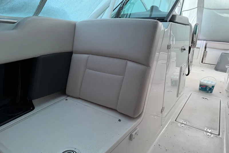 Slide: The Image of 2016 Boston Whaler 270 Vantage interior with cushioned seating and storage compartments. - 14