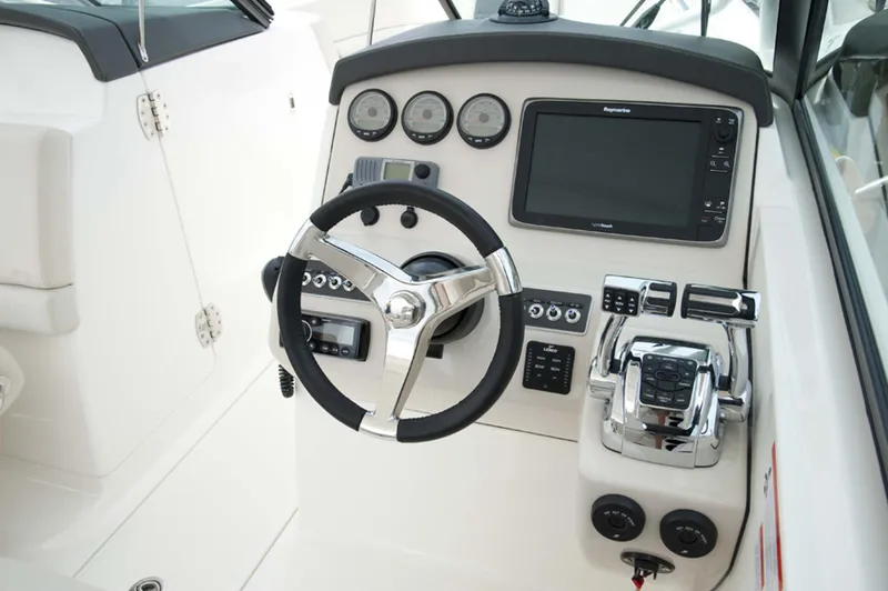 Slide: The Image of Manufacturer Provided Image: Boston Whaler 270 Vantage 2016 helm with steering wheel, gauges, and navigation system. - 21