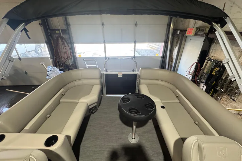 Slide: The Image of 2026 Godfrey Xperience 2286 SBX pontoon boat interior with beige seating and cup holders. - 11