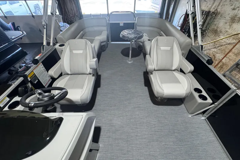 Slide: The Image of 2026 Godfrey Xperience 2286 SBX boat interior with plush seating and modern steering console. - 5