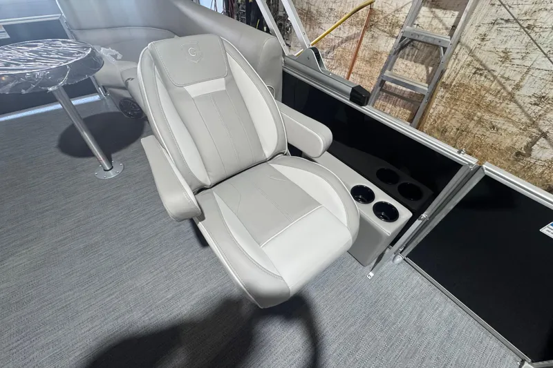 Slide: The Image of Luxurious seating on 2026 Godfrey Xperience 2286 SBX pontoon boat, featuring cup holders and table. - 9