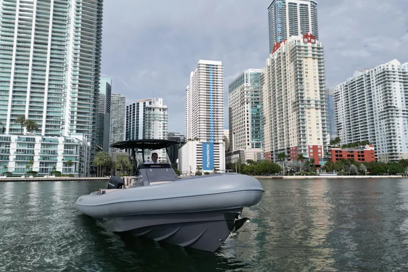 Slide: The Image of 2026 Northstar Orion 8 boat cruising near urban skyscrapers on a calm waterway. - 7