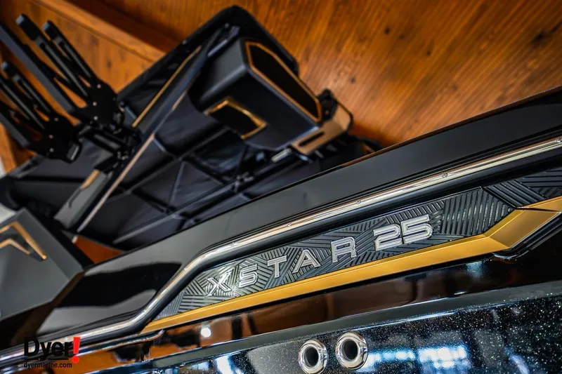 Slide: The Image of 2026 MasterCraft XStar 25 boat, sleek design with metallic accents, close-up view. - 6