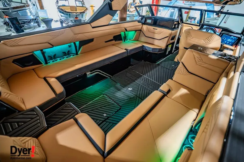 Slide: The Image of Luxurious interior of 2026 MasterCraft XStar 25 boat with tan seating and ambient lighting. - 9