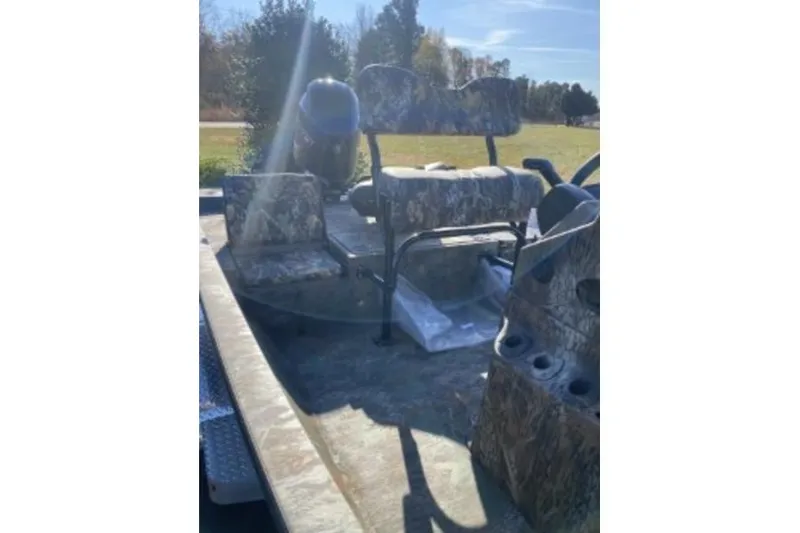 Slide: The Image of 2026 G3 Bay 19 GX boat interior with camouflage seating and sunny outdoor setting. - 10