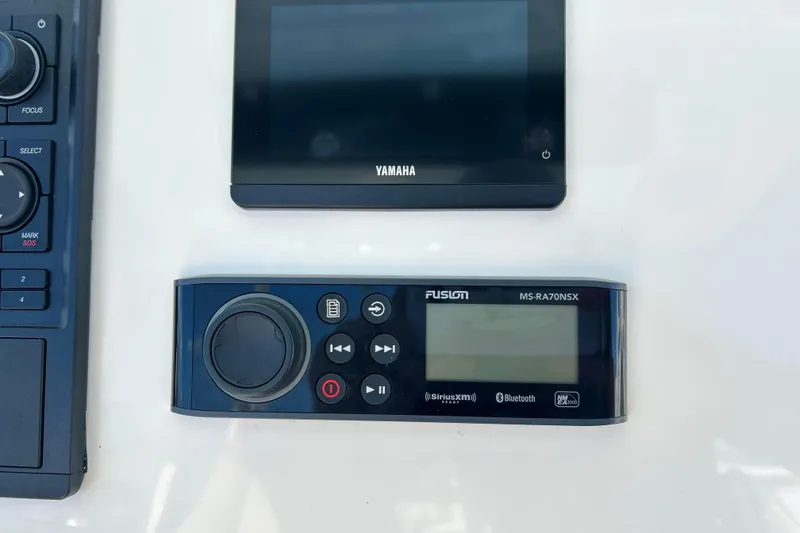 Slide: The Image of Control panel of 2023 Key West 263 FS boat with Yamaha and Fusion audio systems. - 11