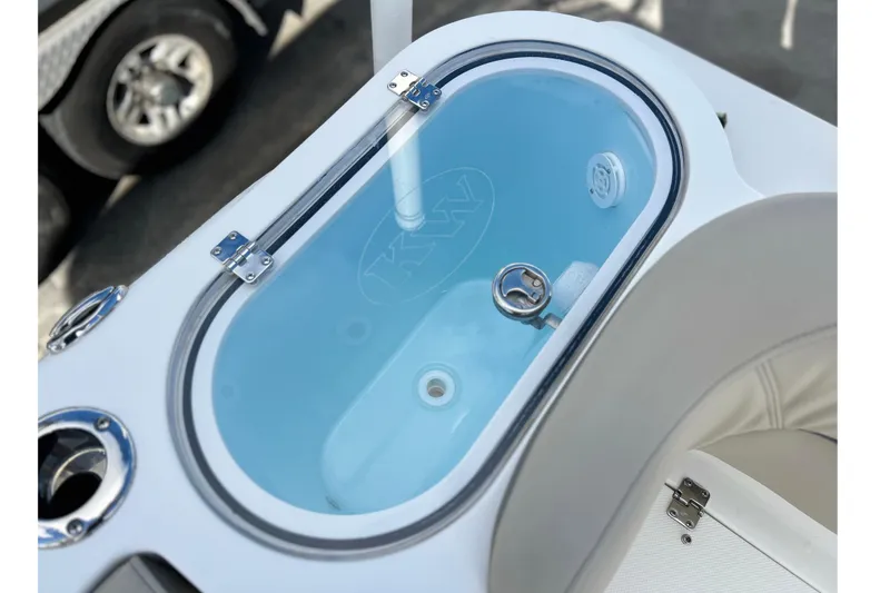 Slide: The Image of Livewell on 2023 Key West 263 FS boat, featuring clear lid and blue interior. - 16