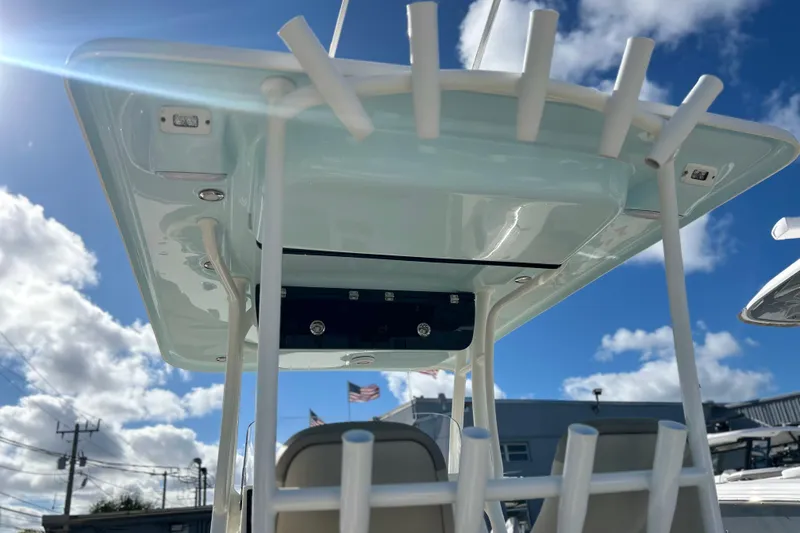 Slide: The Image of 2023 Key West 263 FS boat with T-top and rod holders under a blue sky. - 17