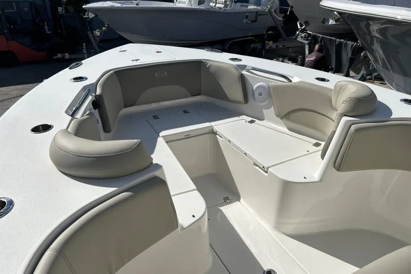 Slide: The Image of 2023 Key West 263 FS boat interior with cushioned seating and storage compartments. - 26