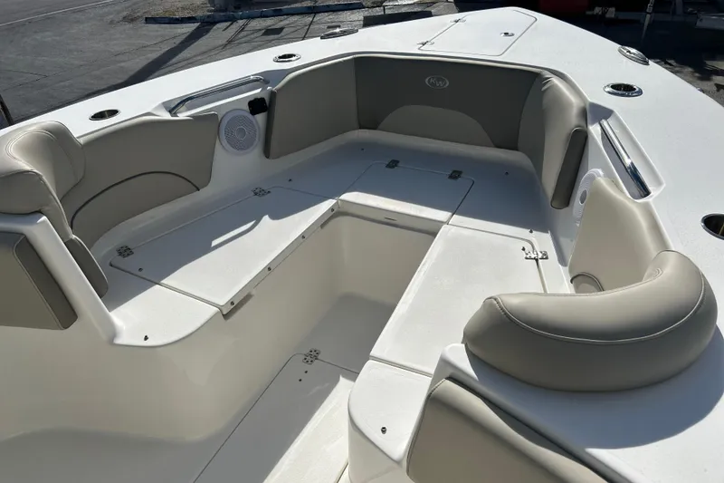 Slide: The Image of 2023 Key West 263 FS boat interior with cushioned seating and storage compartments. - 27