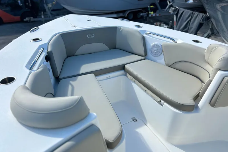 Slide: The Image of 2023 Key West 263 FS boat interior with cushioned seating and cup holders. - 29
