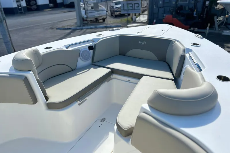 Slide: The Image of 2023 Key West 263 FS boat interior with cushioned seating and cup holders. - 30