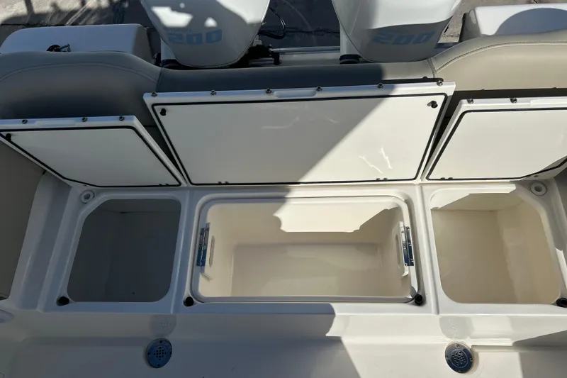 Slide: The Image of 2023 Key West 263 FS boat storage compartments with open lids, showcasing spacious interior. - 32