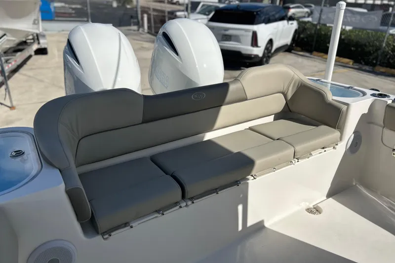 Slide: The Image of 2023 Key West 263 FS boat with beige seating and dual engines. - 37