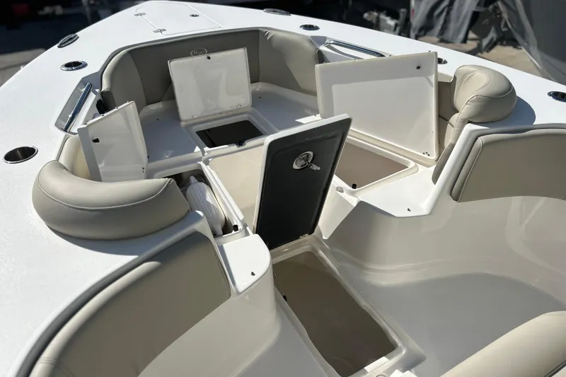 Slide: The Image of 2023 Key West 263 FS boat interior with open storage compartments and cushioned seating. - 39