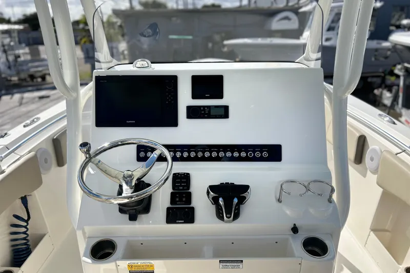 Slide: The Image of 2023 Key West 263 FS boat dashboard with steering wheel and electronic controls. - 5