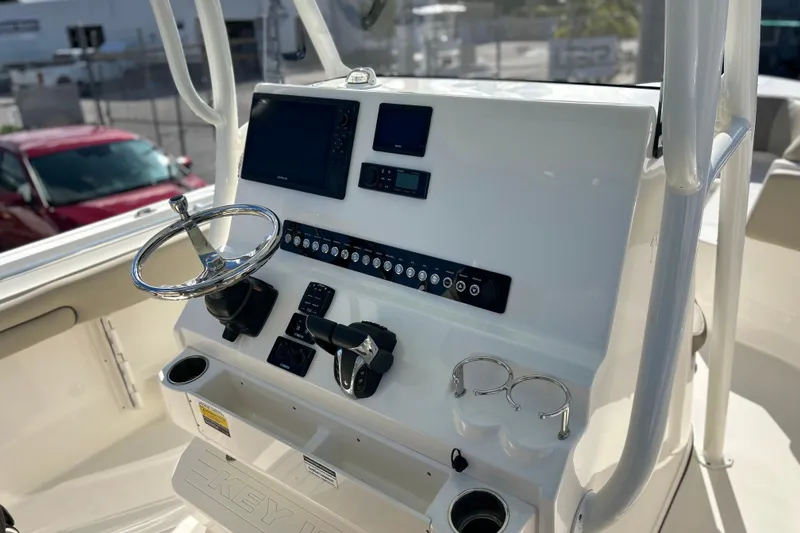 Slide: The Image of 2023 Key West 263 FS boat console with steering wheel and navigation controls. - 8