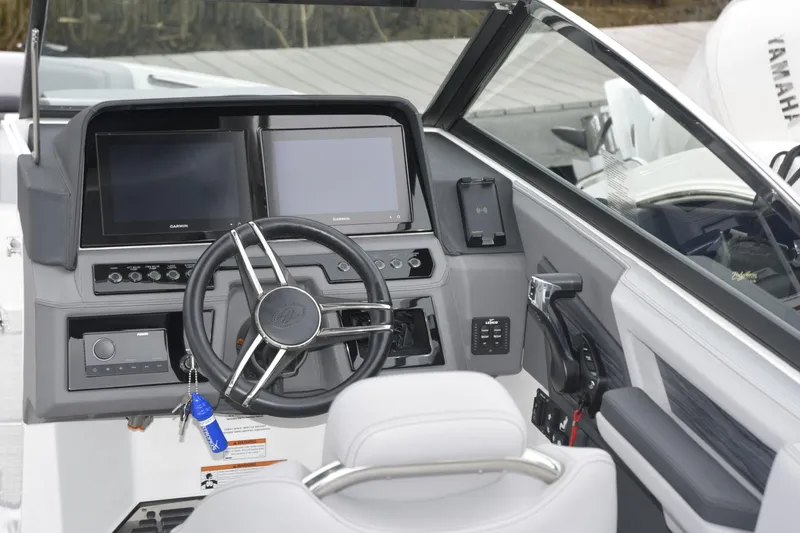 Slide: The Image of 2022 Cobalt R6 Outboard boat dashboard with dual Garmin displays and steering wheel. - 11