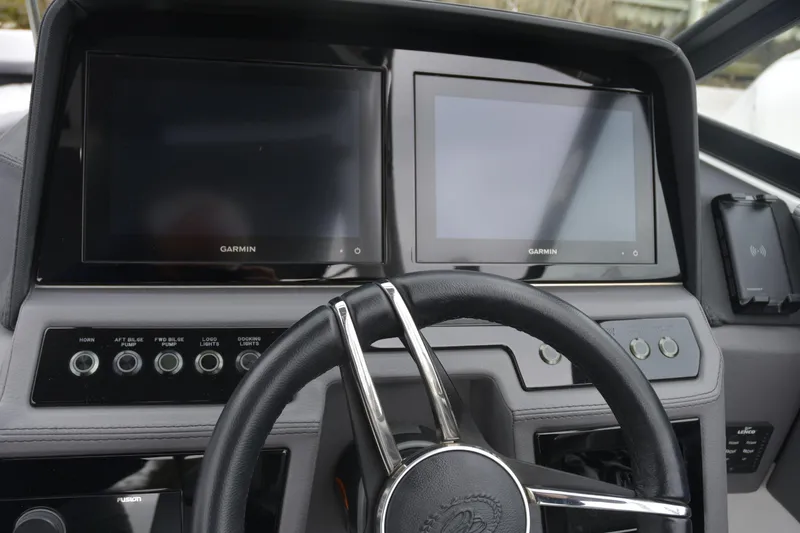 Slide: The Image of 2022 Cobalt R6 Outboard dashboard with Garmin displays and steering wheel. - 13