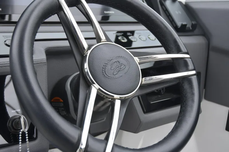 Slide: The Image of Steering wheel of 2022 Cobalt R6 Outboard boat, featuring sleek design and controls. - 14