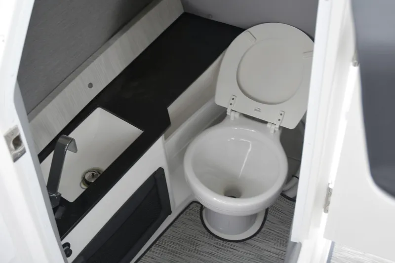 Slide: The Image of 2022 Cobalt R6 Outboard boat interior with toilet and sink. - 18