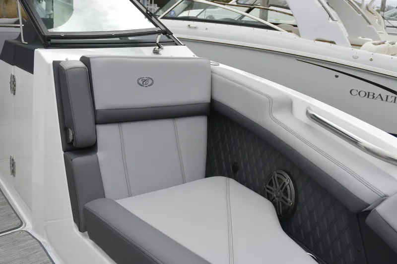 Slide: The Image of 2022 Cobalt R6 Outboard boat interior with gray seating and speaker detail. - 23