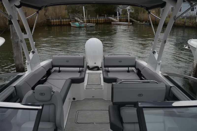 Slide: The Image of 2022 Cobalt R6 Outboard boat interior with gray seating, docked by the water. - 5