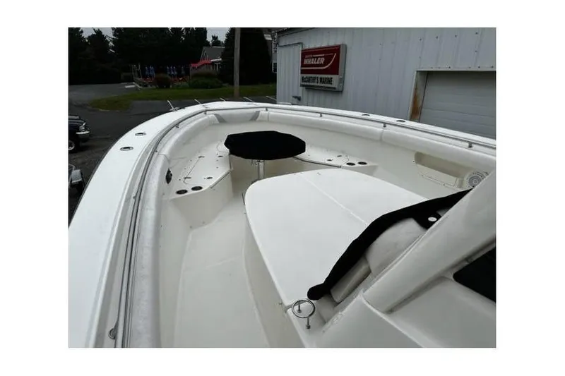 Slide: The Image of 2014 Boston Whaler 370 Outrage boat deck, white interior, outdoor setting. - 1