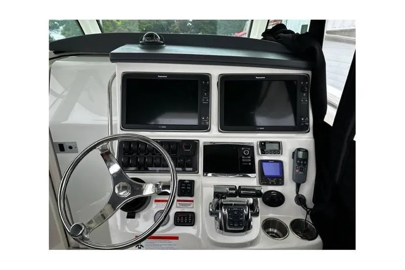 Slide: The Image of 2014 Boston Whaler 370 Outrage helm with dual screens and navigation controls. - 2