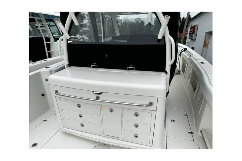 Slide: The Image of 2014 Boston Whaler 370 Outrage interior with storage compartments and seating area. - 5