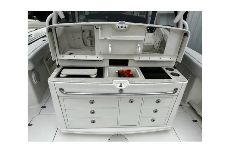Slide: The Image of 2014 Boston Whaler 370 Outrage boat interior with storage compartments and sink. - 6