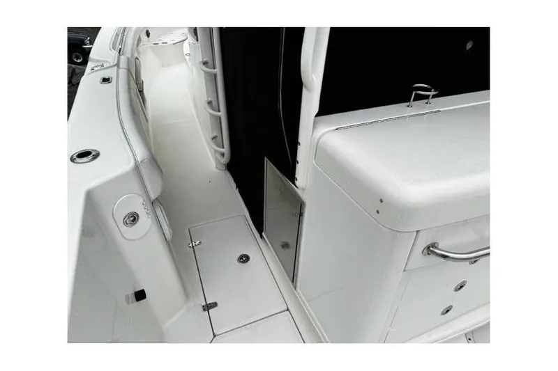 Slide: The Image of 2014 Boston Whaler 370 Outrage boat interior, featuring sleek white deck and storage compartments. - 7