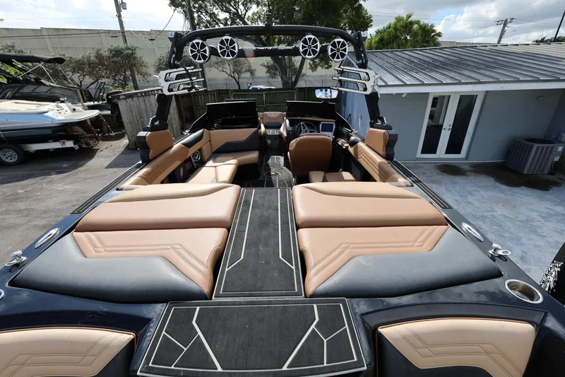 Slide: The Image of 2025 ATX Surf Boats 22 Type-S interior with tan and black seating, sleek design. - 13