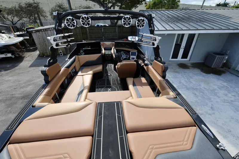 Slide: The Image of 2025 ATX Surf Boats 22 Type-S interior with tan seating and modern audio system. - 14