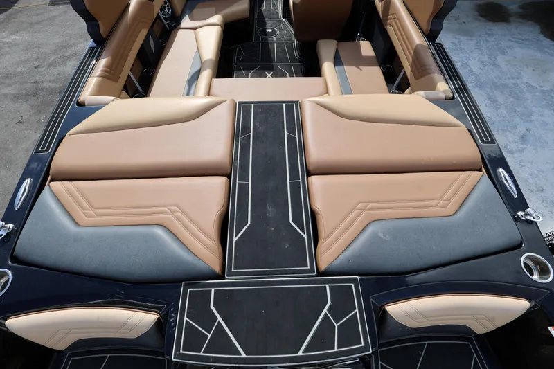 Slide: The Image of 2025 ATX Surf Boats 22 Type-S interior with tan and black seating, modern design. - 15