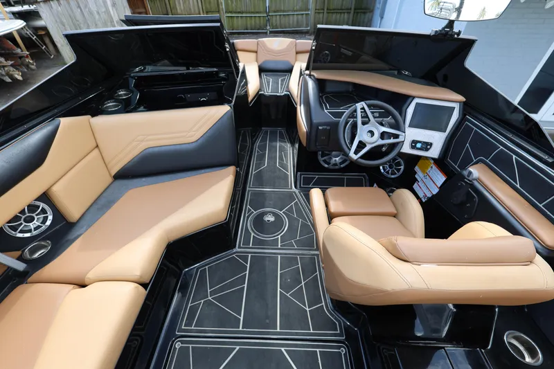 Slide: The Image of 2025 ATX Surf Boats 22 Type-S interior with tan seating and modern dashboard design. - 17