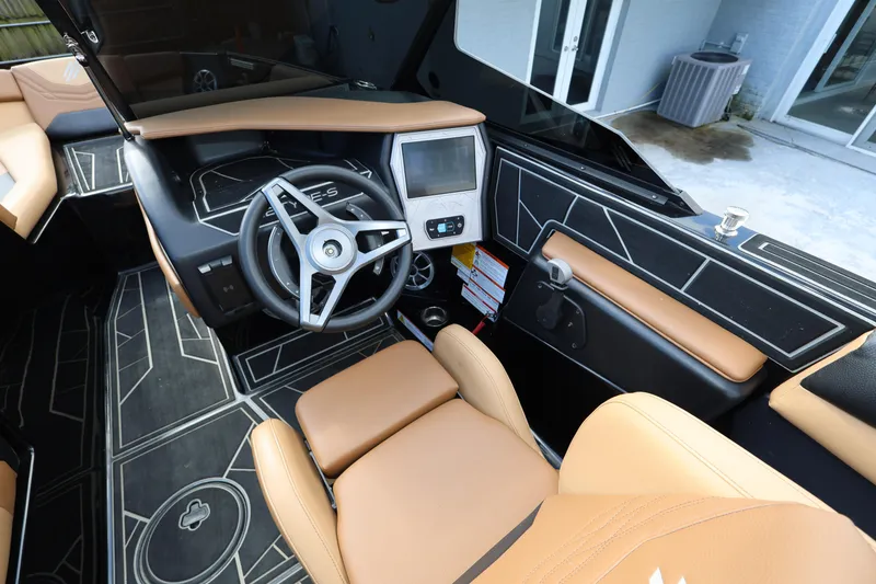 Slide: The Image of 2025 ATX Surf Boats 22 Type-S interior with modern dashboard and tan seating. - 18