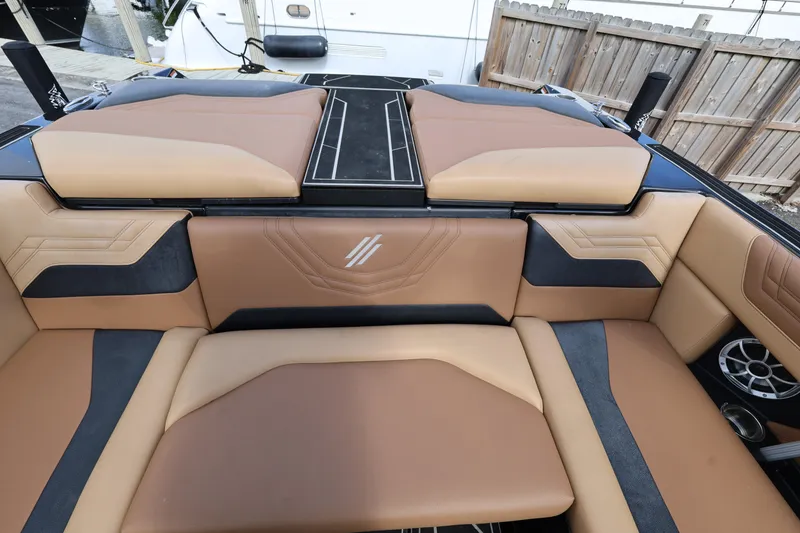 Slide: The Image of 2025 ATX Surf Boats 22 Type-S interior with tan and black seating. - 25