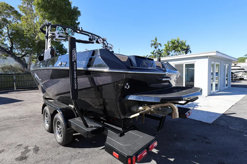 Slide: The Image of 2025 ATX Surf Boats 22 Type-S on trailer, parked outdoors near a building. - 5