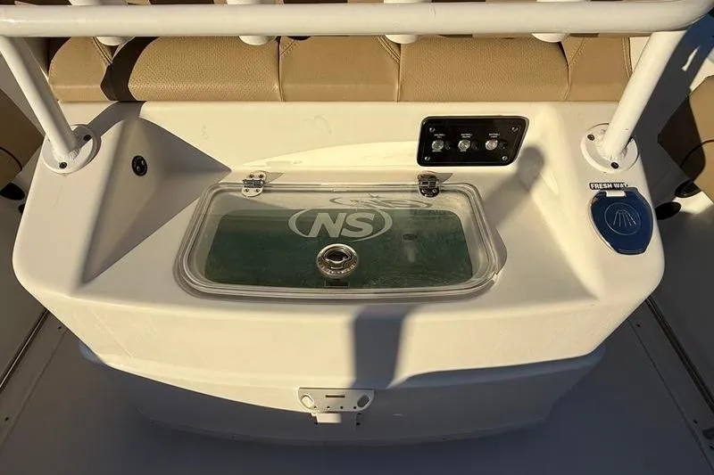 Slide: The Image of 2019 NauticStar 25 XS boat console with livewell and control panel. - 11