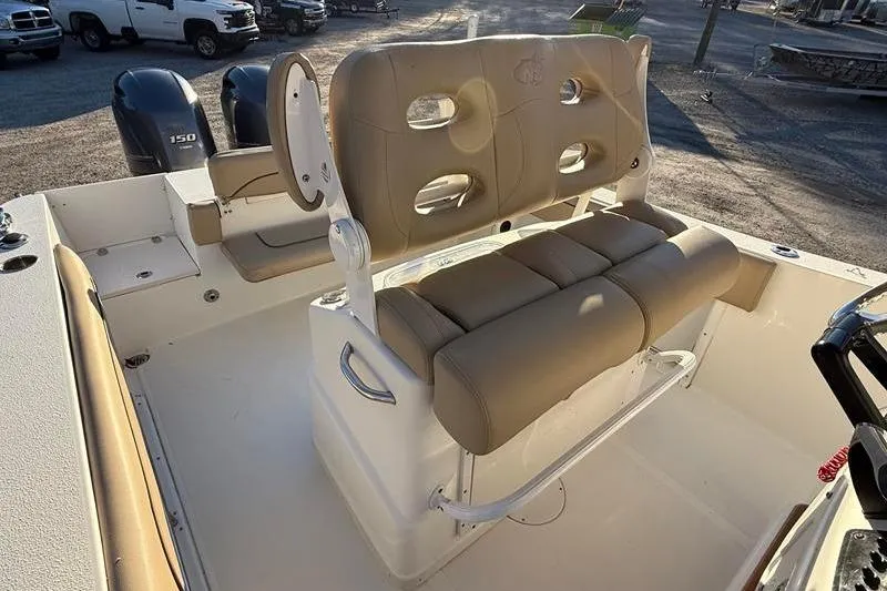 Slide: The Image of 2019 NauticStar 25 XS boat interior with tan seating and dual outboard motors. - 14