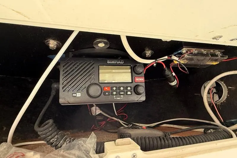 Slide: The Image of Simrad radio equipment inside a 2019 NauticStar 25 XS boat console. - 18