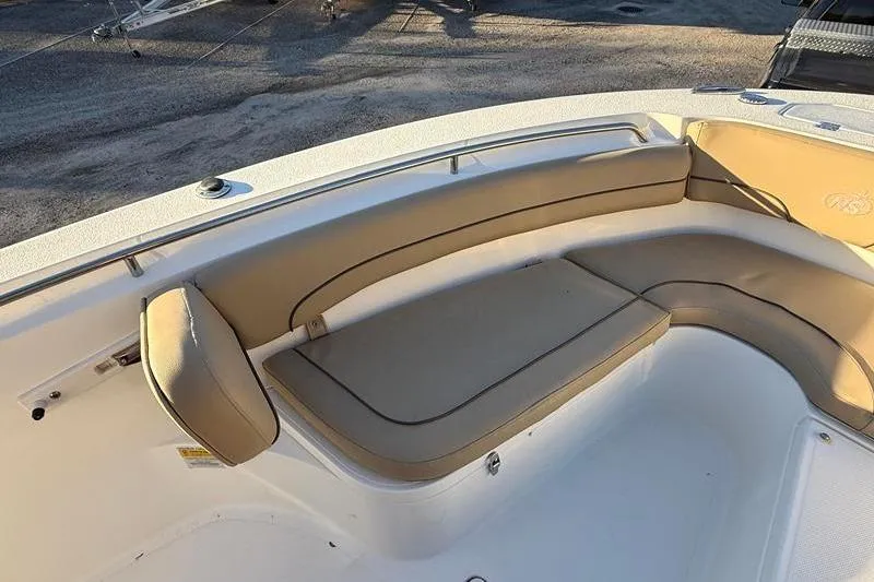 Slide: The Image of 2019 NauticStar 25 XS boat with tan cushioned seating in the bow area. - 23