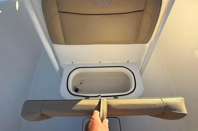 Slide: The Image of 2019 NauticStar 25 XS boat seat with storage compartment open. - 27