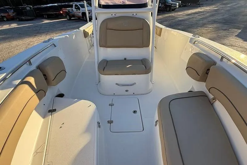 Slide: The Image of 2019 NauticStar 25 XS boat interior with beige seating and white deck. - 28